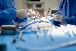 Two surgeons are working on a patient in the operating room.