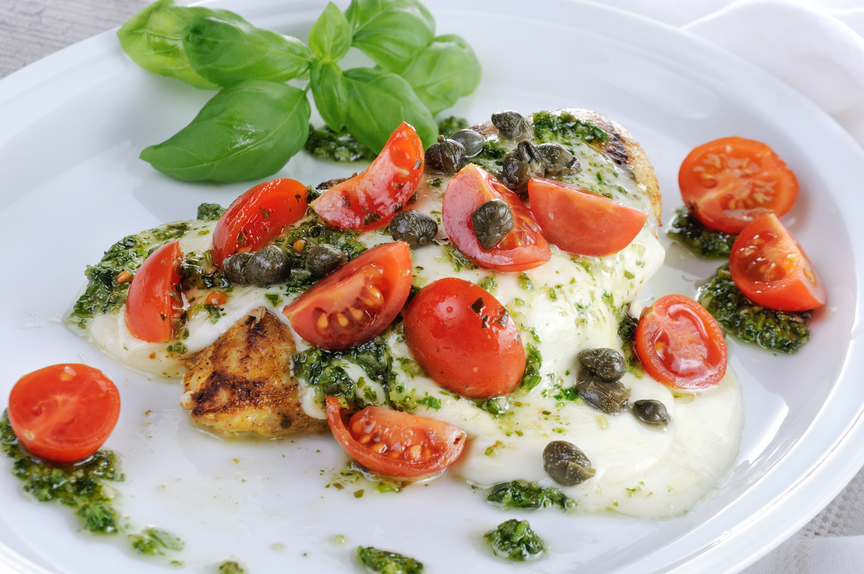 grilled chicken breast topped with melted mozzarella cheese, basil pesto, tomato and caper