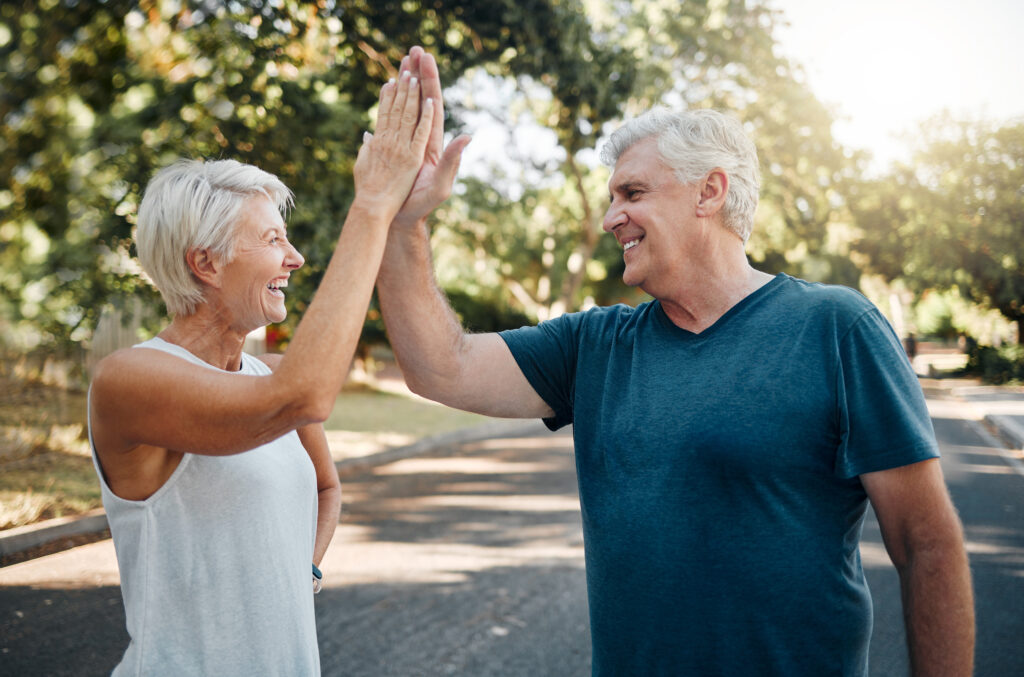 High five, success or senior couple fitness in running workout, exercise